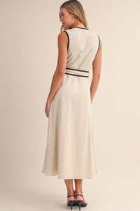 A sleeveless cream-colored midi dress featuring contrast piping wrap details along the neckline and waistband