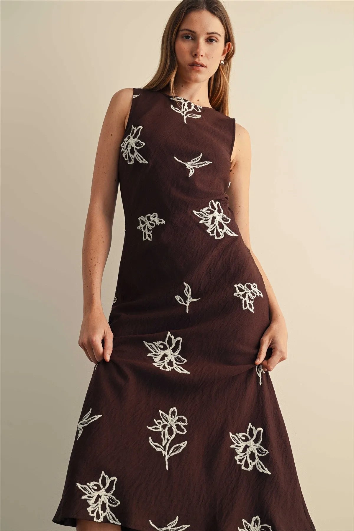 A dark brown embroidery sleeveless midi dress with delicate white floral embroidery across the fabric
