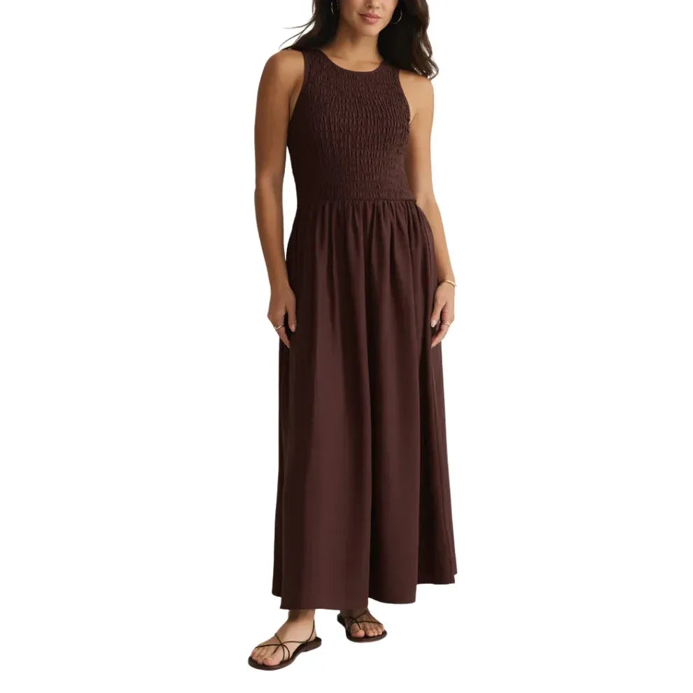 A sleeveless dark brown juniper smocked maxi dress with a textured bodice and flowing skirt for elegant wear