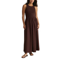 A sleeveless dark brown juniper smocked maxi dress with a textured bodice and flowing skirt for elegant wear