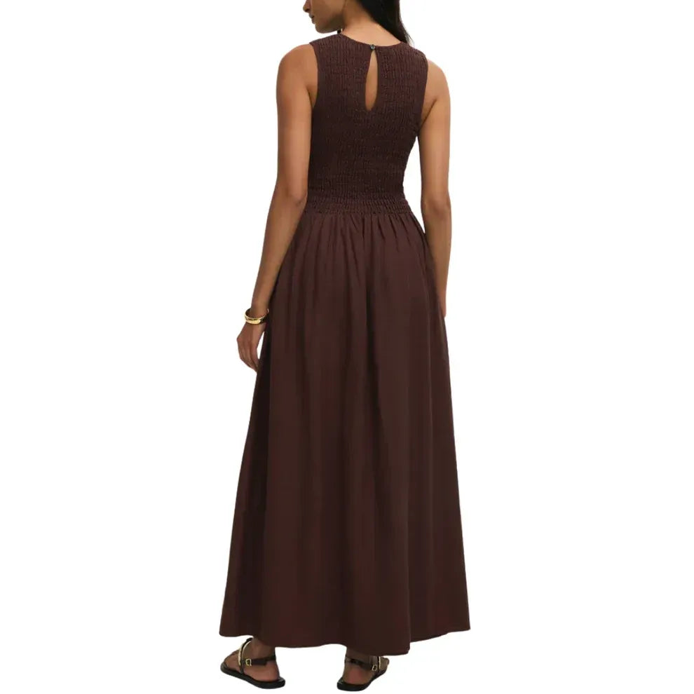 A sleeveless dark brown maxi dress with ribbed bodice and smocked waistband in juniper smocked maxi design