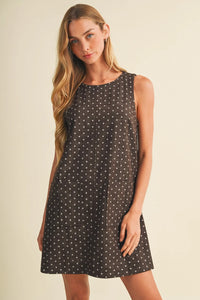 Polka dot sleeveless mini dress in dark gray with subtle white dots and two front pockets for casual wear
