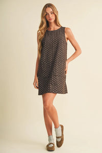 Sleeveless dark gray polka dot mini dress with a subtle white dot pattern and relaxed a-line silhouette