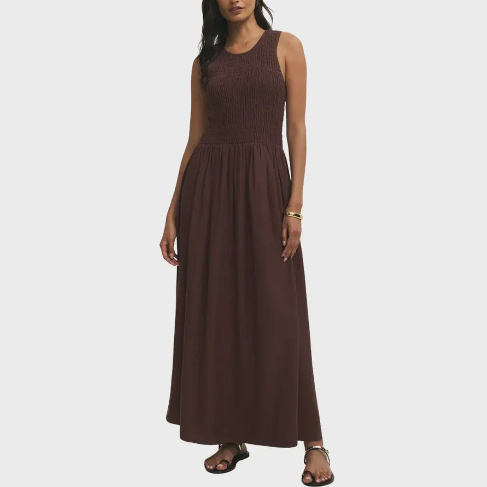 A sleeveless brown juniper smocked maxi dress featuring a ribbed bodice and flowing floor-length skirt
