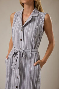 A sleeveless gray and white striped button-down midi dress with a matching waist tie belt at the waist