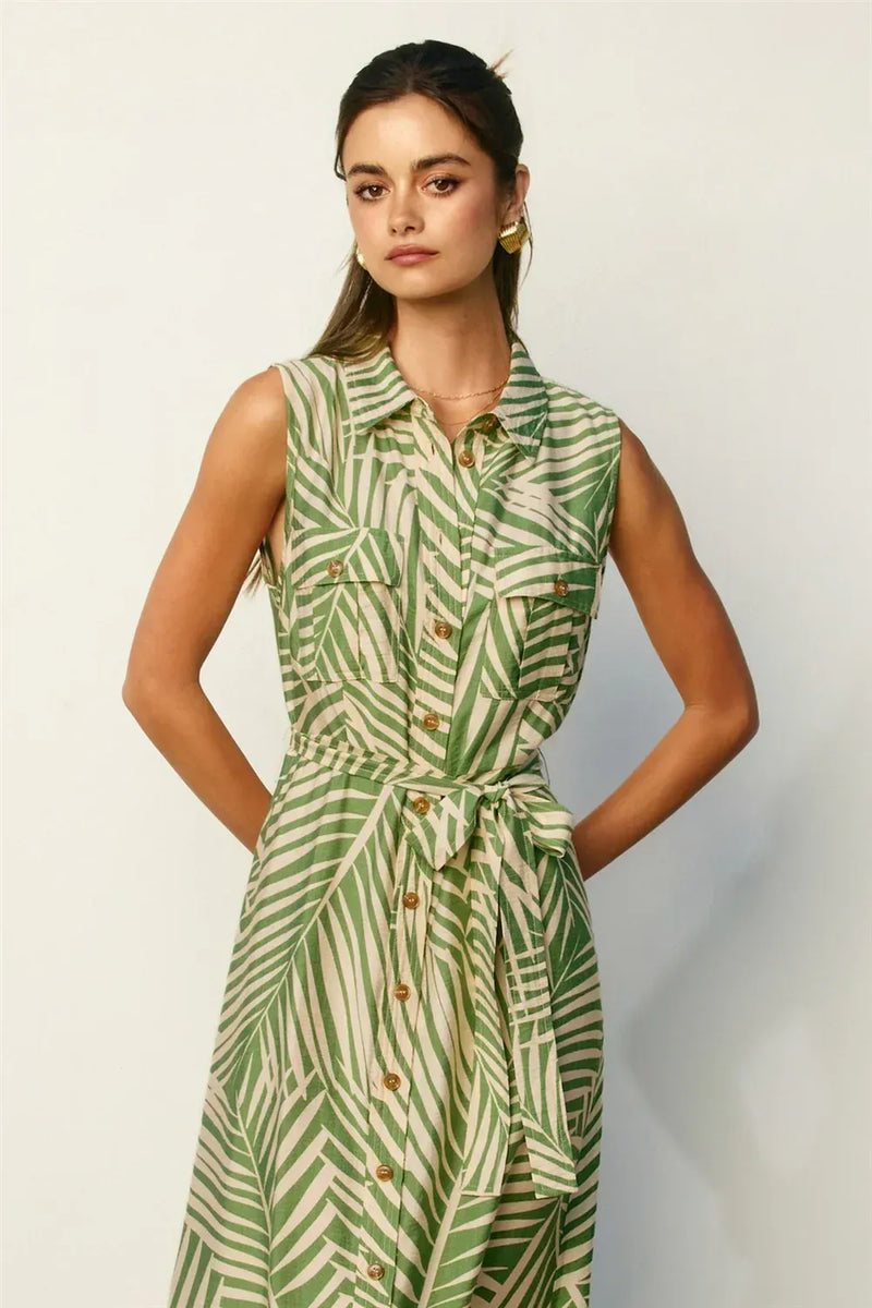 Wild tides shirt dress featuring a sleeveless green and cream leaf-patterned button-down design with belted waist