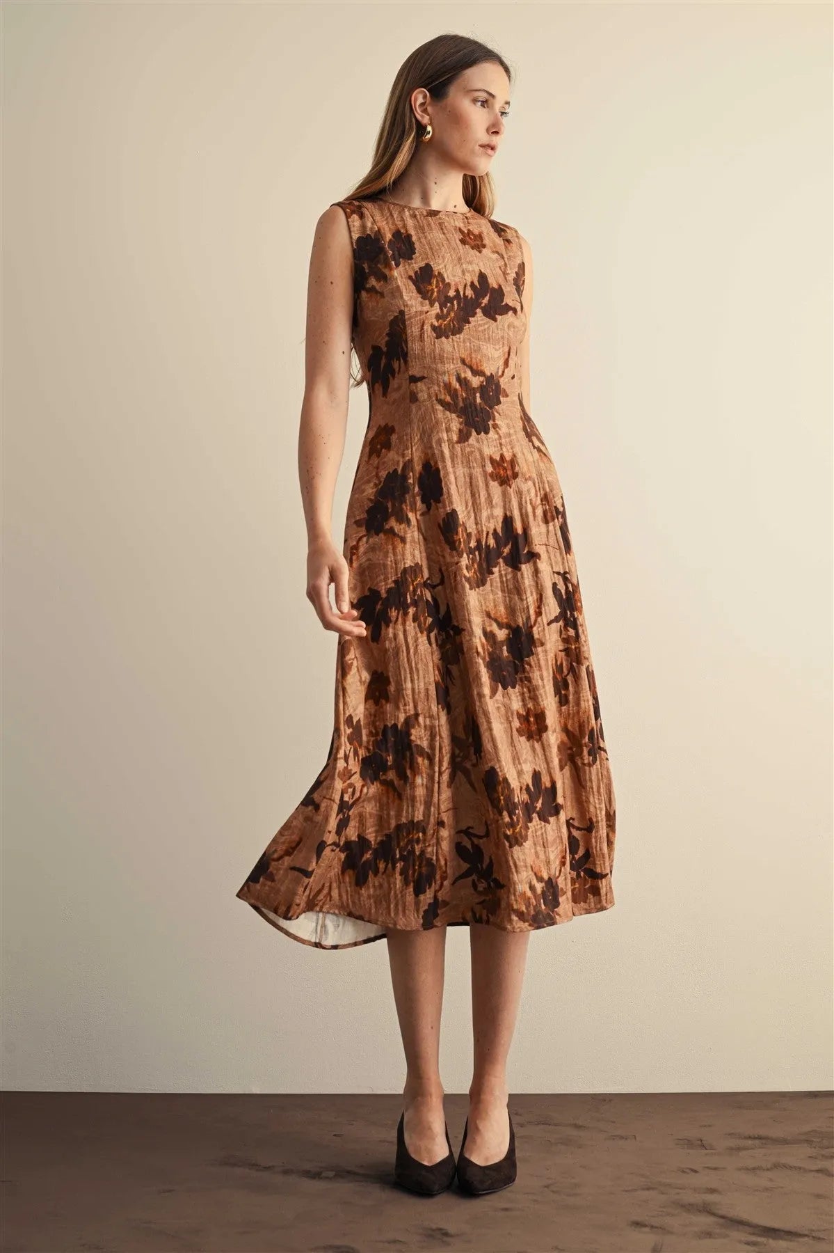 A sleeveless midi dress in textured tan fabric with dark brown floral embroidery flower print sleeveless design