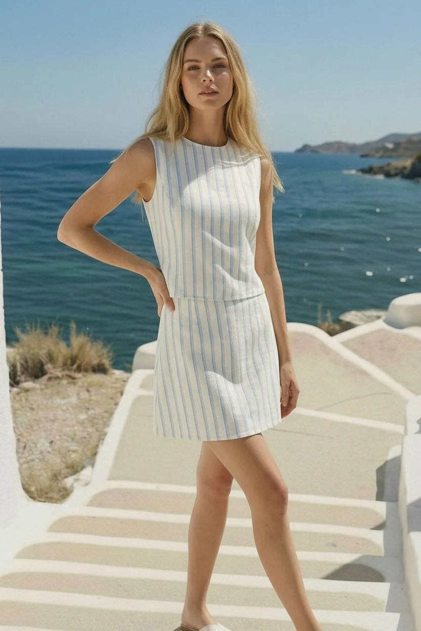 Women’s boho chic clothing featuring a stripe open back tie sleeveless top in white with thin vertical blue stripes