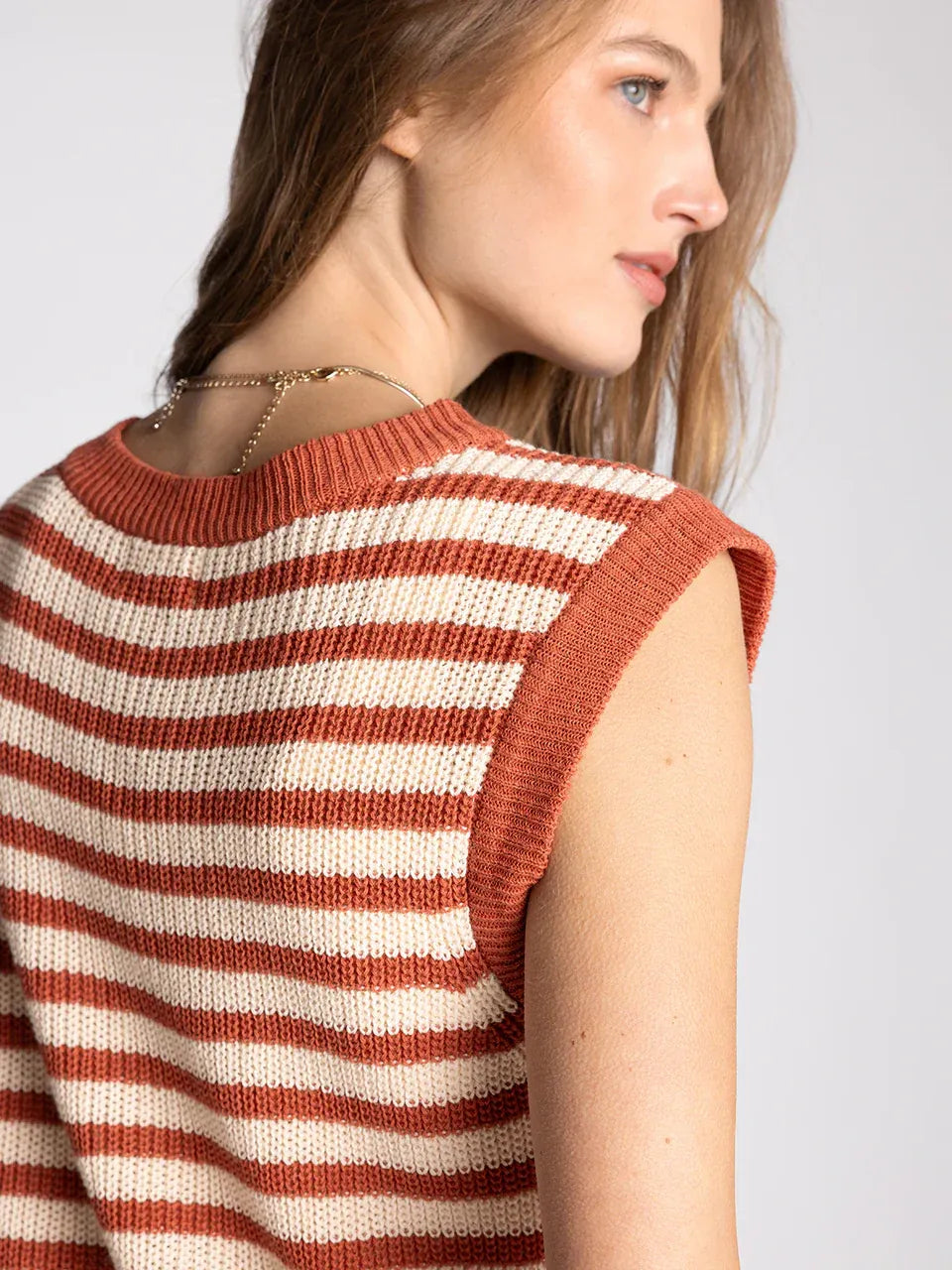 A sleeveless knitted supply orta top with terracotta and cream stripes and ribbed edges for women’s boho chic clothing