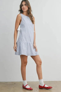 Sleeveless light blue and white gingham flounce mini dress with ruffled hemline side tie gingham flounce mini dress
