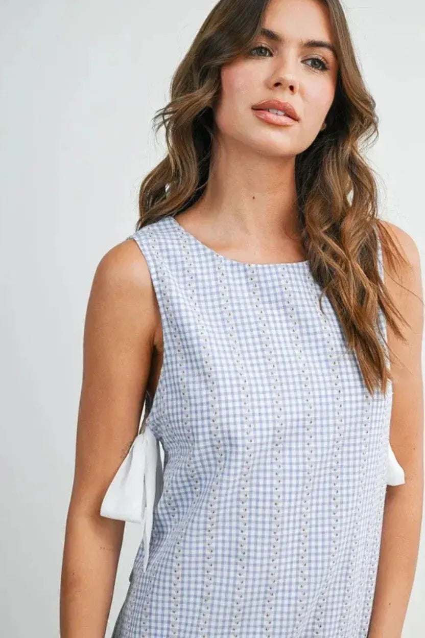 Side tie gingham flounce mini dress in light blue and white gingham with eyelet detailing and shoulder ties