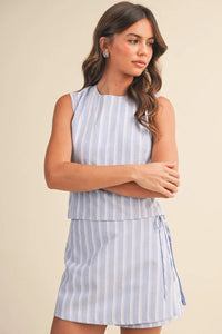 A sleeveless light blue and white vertically striped zipper wrap skort with a tiered hemline for casual wear