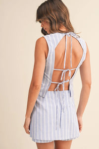 Back view of a sleeveless light blue and white striped zipper wrap skort with a tie-up design and side zipper closure