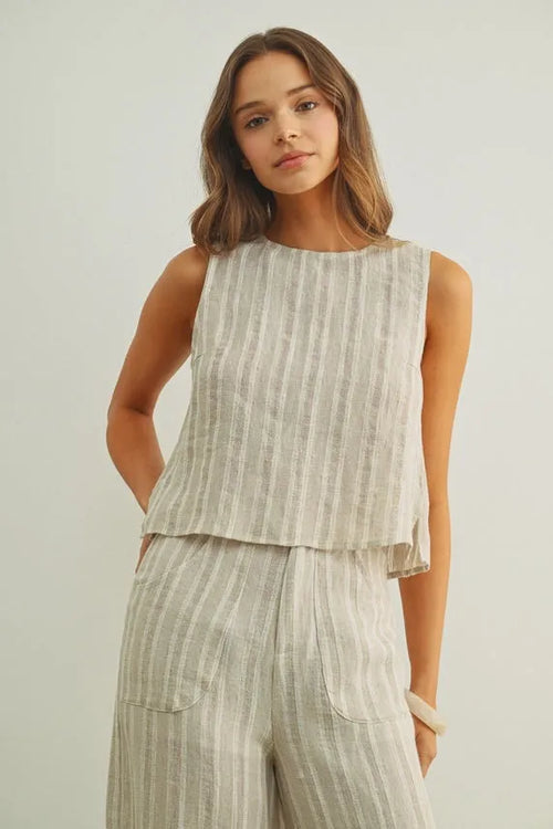 Jacquard linen sleeveless top in light gray and white stripes with a tiered hemline and linen twisted tie back detail