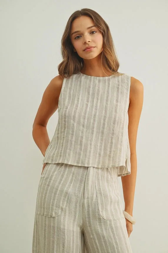 Jacquard linen sleeveless top in light gray and white stripes with a tiered hemline and linen twisted tie back detail