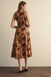 A sleeveless midi dress in textured brown fabric with dark leaf patterns featuring a flower print sleeveless design
