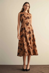 Flower print sleeveless midi dress in warm beige fabric with dark brown floral pattern and subtle vertical pleats