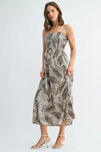 A soft gray leaf print smocking midi dress with elegant brown leaf pattern and delicate spaghetti straps