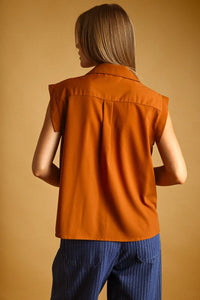 Sleeveless orange chiffon blouse with collar pocket button and subtle pleats at the back
