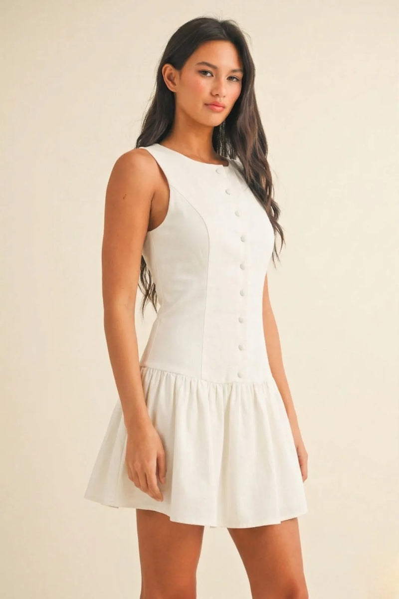 White sleeveless mini dress with round neck button-front design and flared skirt perfect for summer wear