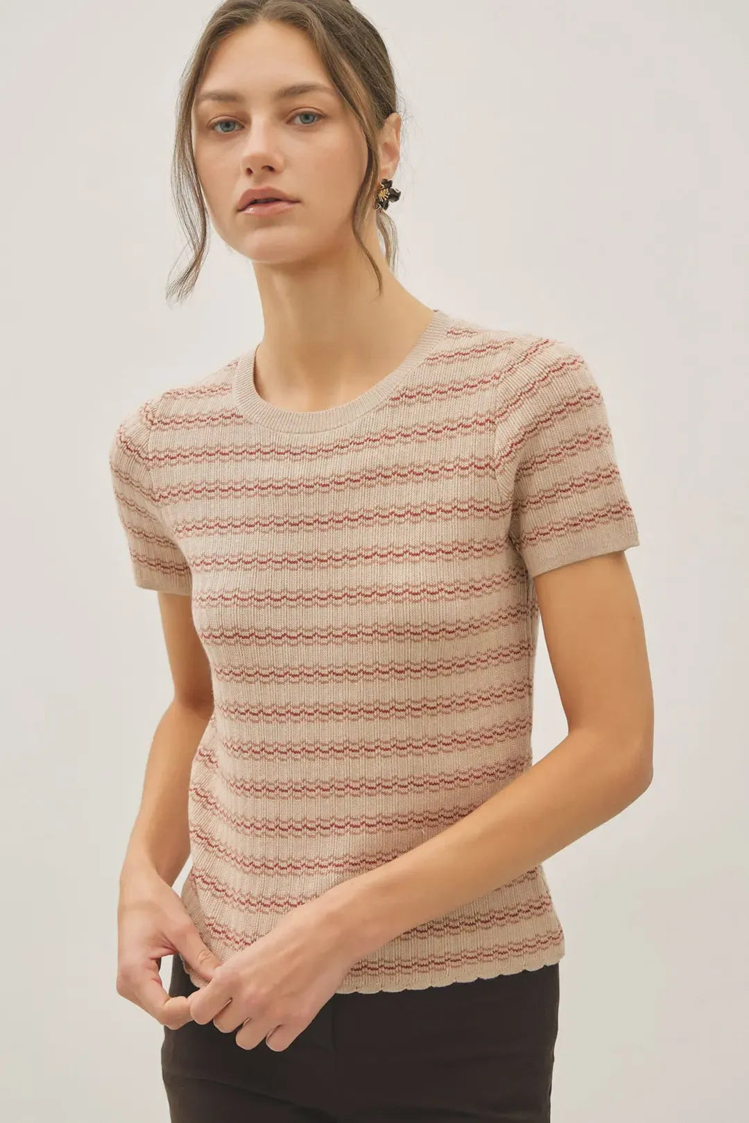 A soft beige and terracotta striped ribbed knit scallop edge short sleeve sweater top with a scalloped hem