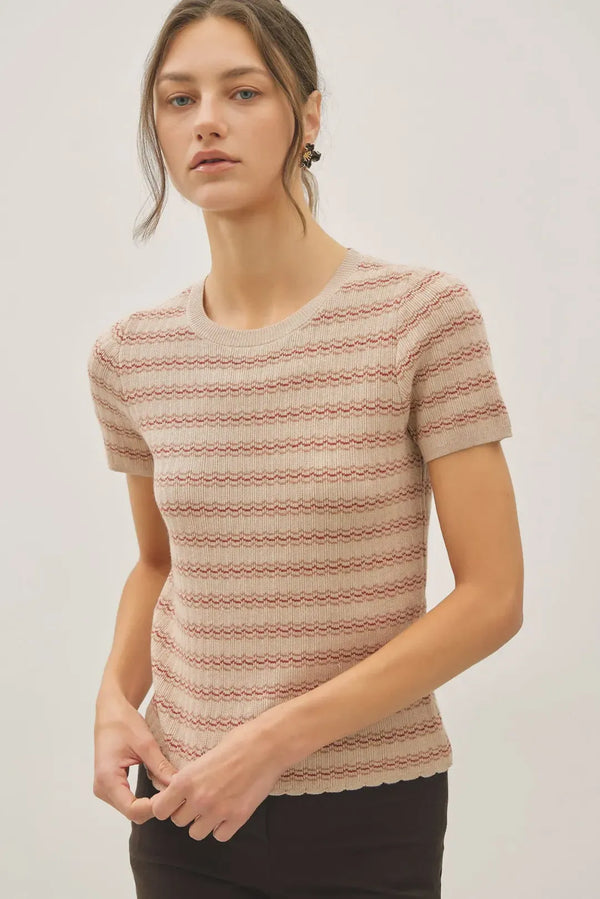 A soft beige and terracotta striped ribbed knit scallop edge short sleeve sweater top with a scalloped hem