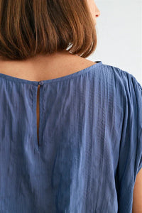 Back view of Crinkle Satin Elastic Hem Top in soft blue textured cotton