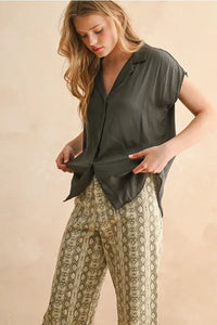 A lightweight button down cap sleeve shirt in soft dark olive green silk with a relaxed fit and short sleeves