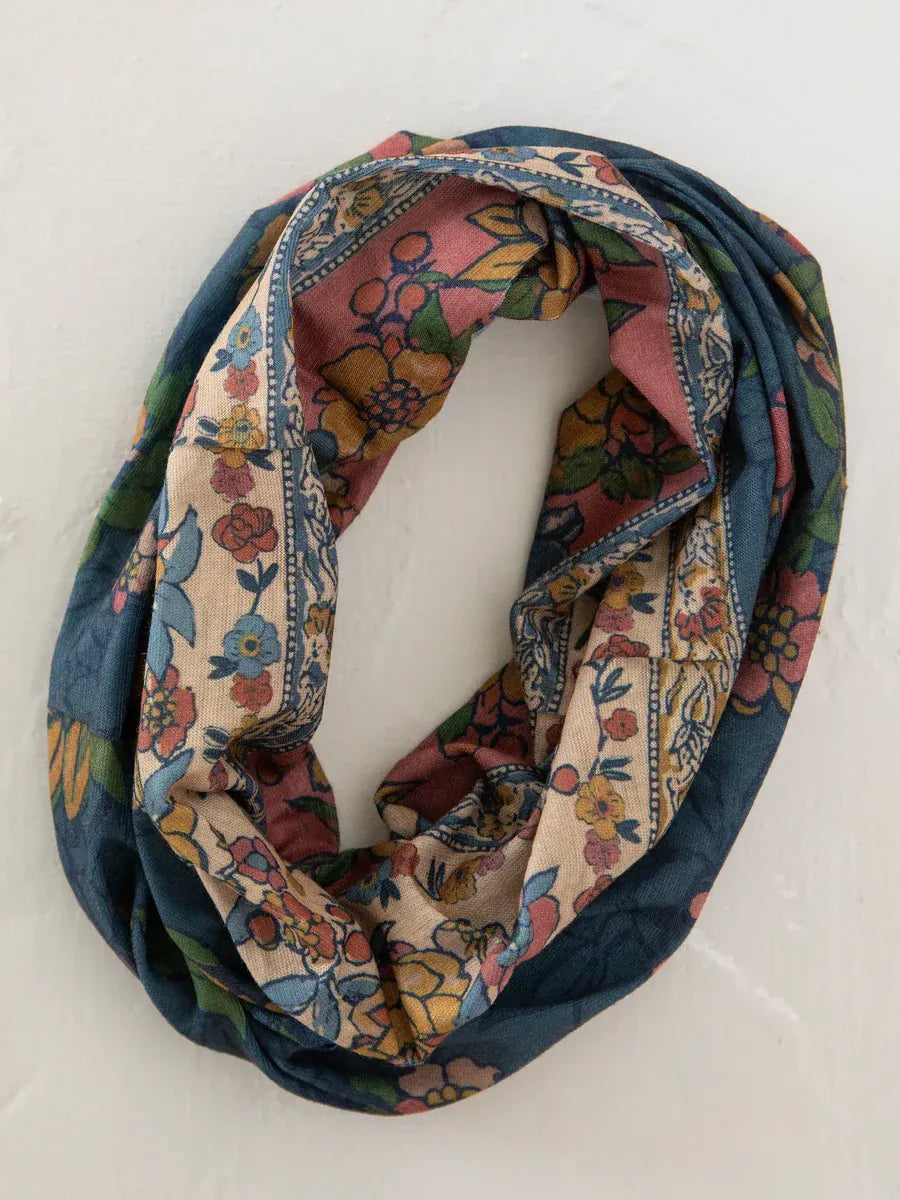 A soft floral-patterned infinity scarf with delicate embroidery in riviera batik blue pink and cream shades