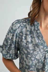 A soft gray v-neck smocking blouse with delicate white floral pattern and puffed short sleeves for women’s boho chic clothing