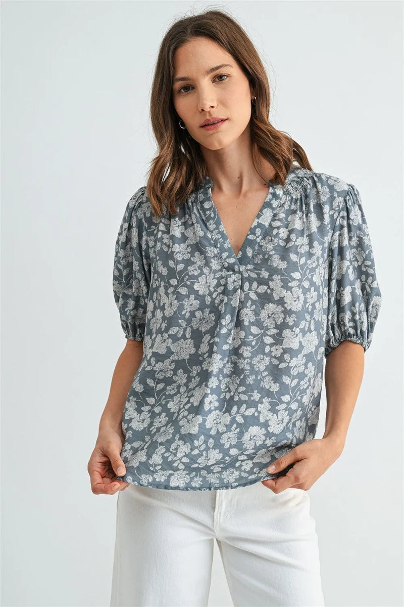 A soft gray v-neck smocking detail blouse with delicate white floral pattern and puffed short sleeves for women’s boho chic clothing