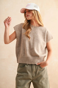 Loose fit short sleeve sweater top in soft heathered beige knit with ribbed hem and neckline, not olive green