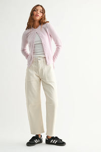 Soft lavender knit cardigan over white top with utility seamed barrel jean
