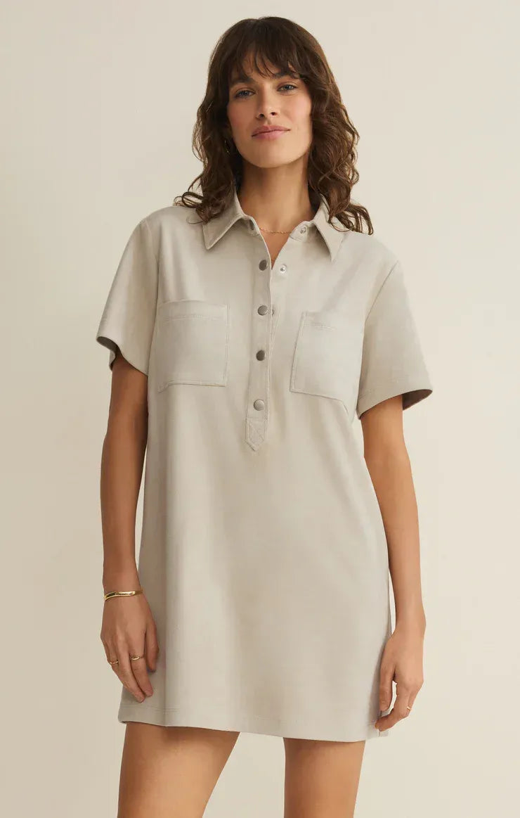 A soft light beige danna faux suede mini dress with short sleeves collar and front button closure