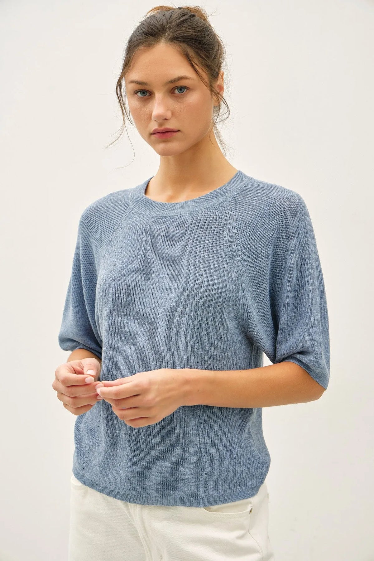 Lightweight ribbed knit raglan short sleeve top in soft light blue with relaxed fit and breathable fabric