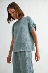 Texture dolman sleeve woven top in soft light blue textured fabric