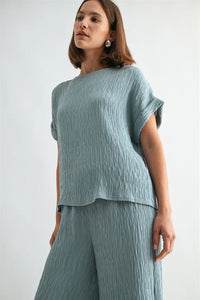 Texture dolman sleeve woven top in soft light blue textured fabric