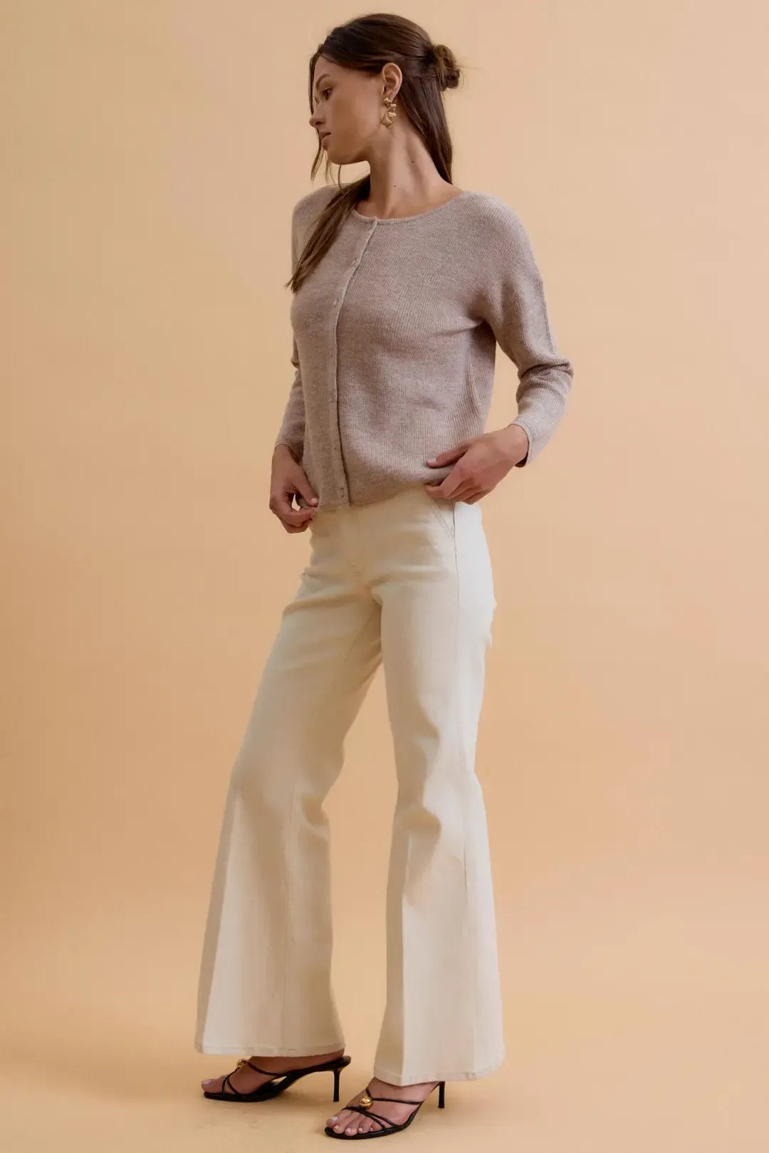 A soft light gray round neck wool ribbed cardigan with long sleeves and a subtle textured pattern