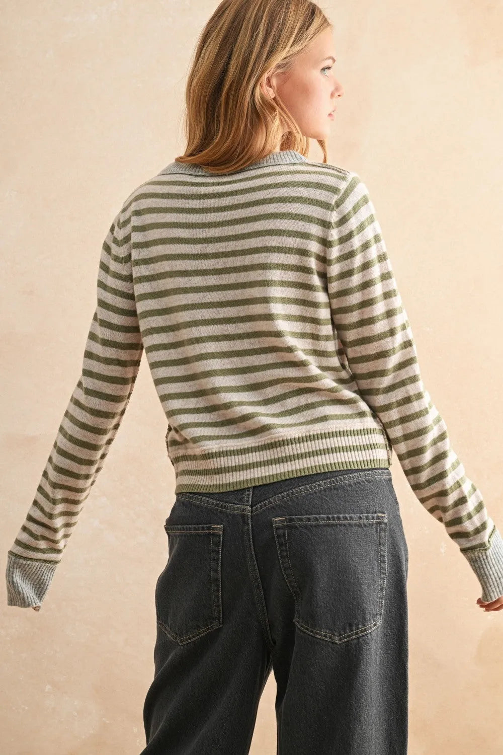 A soft long-sleeved striped pattern button front cardigan in muted olive and cream tones with pattern button details