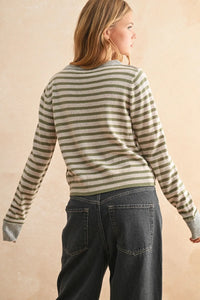 A soft long-sleeved striped pattern button front cardigan in muted olive and cream tones with pattern button details