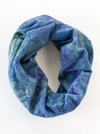 A soft looped boho bandeau headband in navy patchwork with subtle floral and abstract patterns