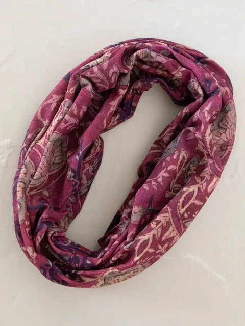 A soft maroon boho bandeau headband with a floral and paisley pattern in muted pink and purple tones