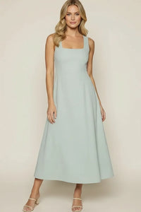A soft mint green sleeveless vista marina maxi dress with a square neckline and flowing skirt by lost + wander