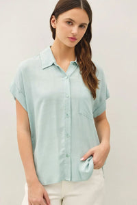 A soft mint green solid short sleeve button down shirt with classic collar and chest pocket for casual wear