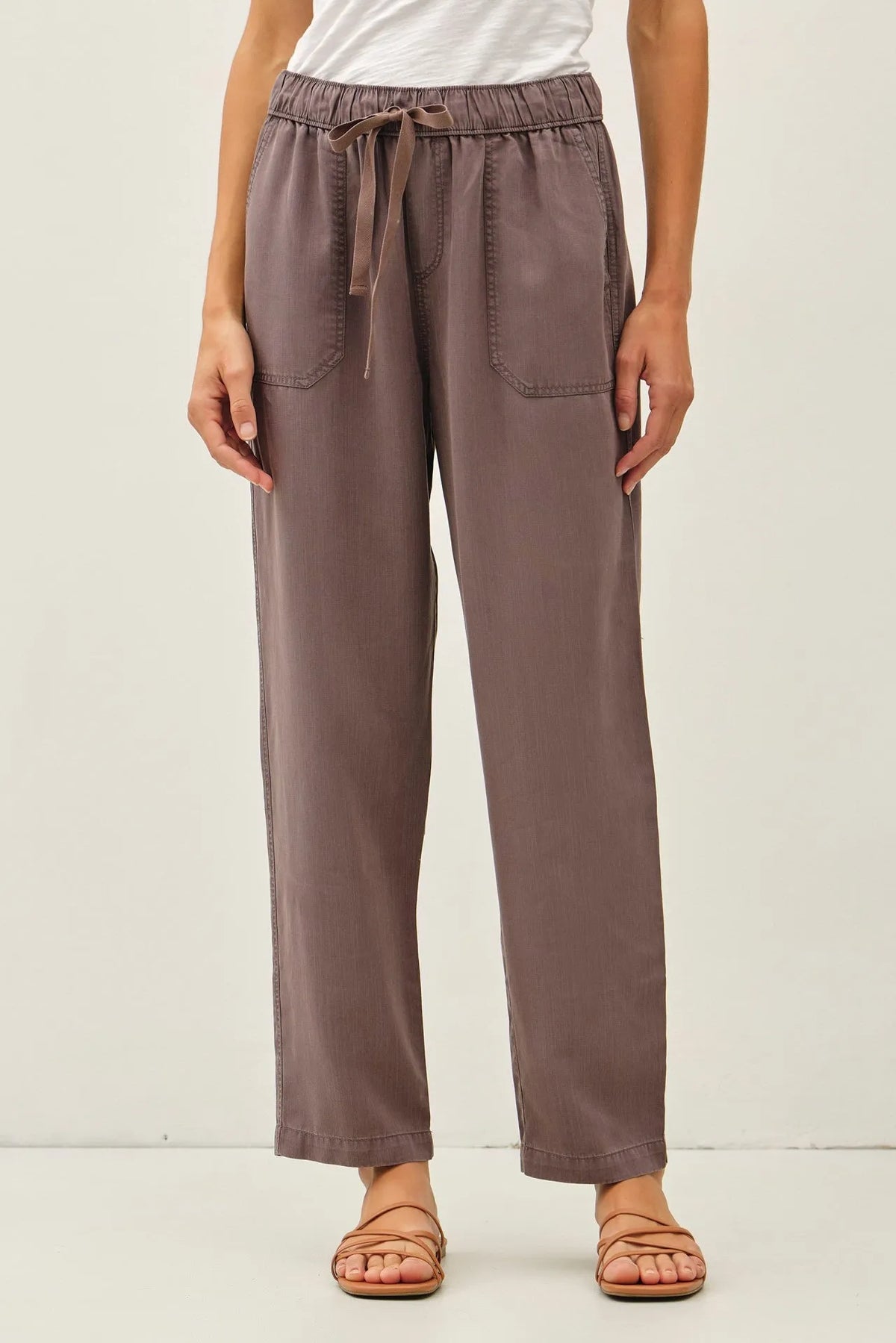 Soft muted taupe tencel tapered pants with wide-leg fit drawstring waist and two front pockets