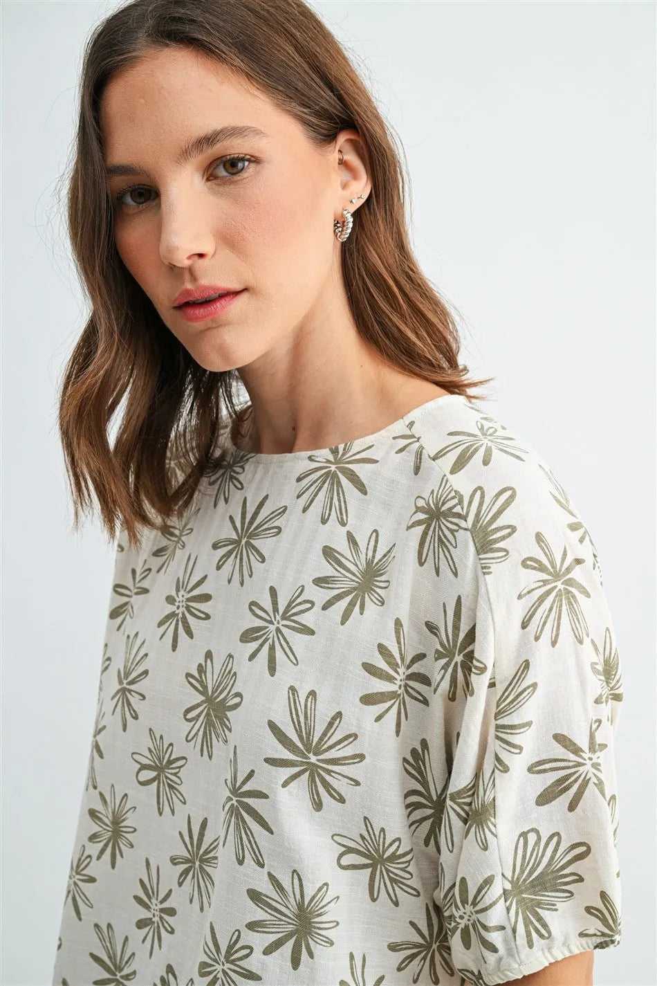 A soft off-white flower print dolman blouse with olive-green floral pattern and puffed sleeves