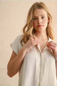 A soft off-white lightweight button cap sleeve shirt with short sleeves and a relaxed fit for casual wear