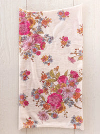 A full boho bandeau headband in english garden cream features soft off-white cotton with vibrant floral patterns