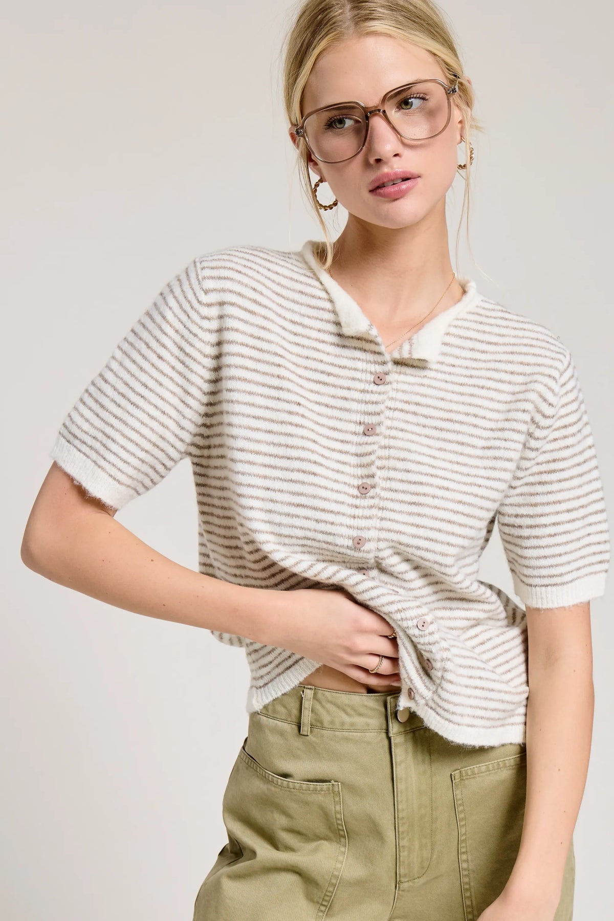 A soft off-white and gray striped short sleeve button cardigan knit top with a button-down front