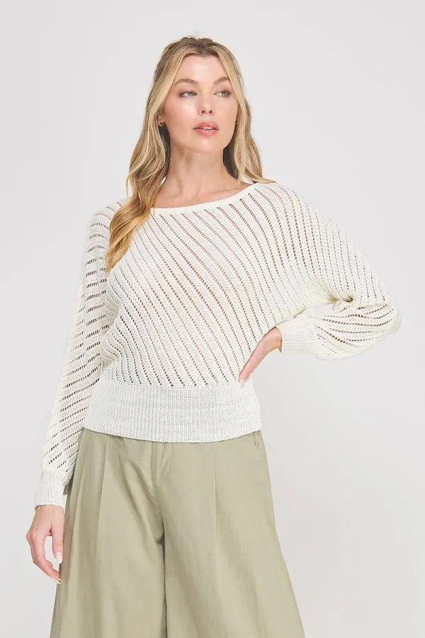 A soft off-white hand yarn open stitch dolman sweater top with ribbed waistband and diagonal striped long sleeves